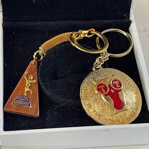 Two keychains. Winnipeg sports and an advertising t t  Keychain with Red Accents